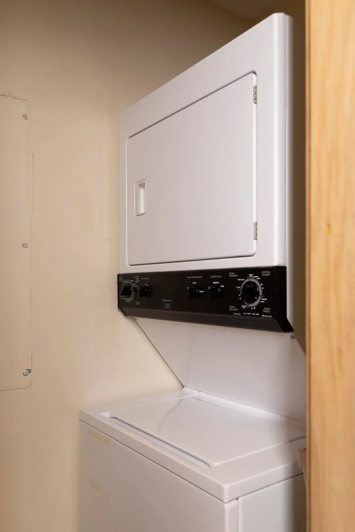 A tidy laundry area with both a washer and dryer, ready for guest use. The setting is practical and straightforward, emphasizing the convenience of on-site laundry facilities.